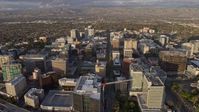 6K stock footage aerial video of approaching and flying over office buildings in Downtown San Jose at sunset, California Aerial Stock Footage | AX0174_0038