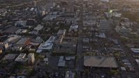 6K stock footage aerial video of a reverse view of city street and office and apartment buildings in Downtown San Jose at sunset, California Aerial Stock Footage | AX0174_0039