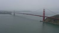 6K stock footage aerial video of passing by the Golden Gate Bridge on a foggy day, San Francisco, California Aerial Stock Footage | AX0175_0067