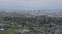 6K stock footage aerial video of Downtown Oakland seen from suburbs in Alameda, California Aerial Stock Footage | AX0175_0097