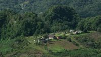 4.8K stock footage aerial video of a Farmhouse nestled in at lush green forest, Karst Forest, Puerto Rico Aerial Stock Footage | AX101_070