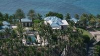 4.8K stock footage aerial video of an Oceanfront mansion and palm trees, Little St James Island, St Thomas Aerial Stock Footage | AX102_252