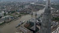 5.5K stock footage aerial video of flying by The Shard skyscraper for view of Tower Bridge, London, England Aerial Stock Footage | AX114_023