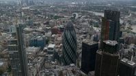 5.5K stock footage aerial video orbiting The Gherkin and neighboring skyscrapers, Central London, England Aerial Stock Footage | AX114_027