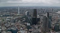 5.5K stock footage aerial video of The Gherkin and nearby skyscrapers, The Shard in the distance, Central London, England Aerial Stock Footage | AX114_030