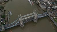 5.5K stock footage aerial video tilt to a bird's eye view of the Tower Bridge over River Thames, London, England Aerial Stock Footage | AX114_051