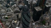 5.5K stock footage aerial video of tilting to a bird's eye view of The Gherkin skyscraper, Central London, England Aerial Stock Footage | AX114_074
