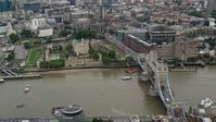 5.5K stock footage aerial video of Tower of London with view of Tower Bridge and River Thames, England Aerial Stock Footage | AX114_121