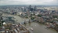 5.5K stock footage aerial video of the Tower Bridge and Central London skyscrapers near the river, England Aerial Stock Footage | AX114_124