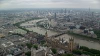 5.5K stock footage aerial video fly over Big Ben, Parliament and Westminster Abbey toward London Eye, England Aerial Stock Footage | AX114_196