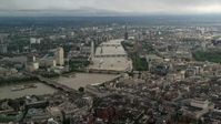 5.5K stock footage aerial video approach bridges over the River Thames and London Eye, England Aerial Stock Footage | AX115_118