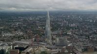 5.5K stock footage aerial video of orbiting The Shard overlooking cityscape, London, England Aerial Stock Footage | AX115_179
