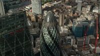 5.5K stock footage aerial video tilt to the top of The Gherkin during approach, Central London, England Aerial Stock Footage | AX115_190