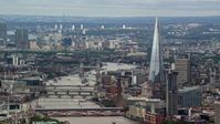 5.5K stock footage aerial video of The Shard and Tower Bridge spanning the Thames, reveal Canary Wharf, London, England Aerial Stock Footage | AX115_247