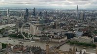 5.5K stock footage aerial video of skyscrapers in Central London, London Eye and Parliament, England Aerial Stock Footage | AX115_255