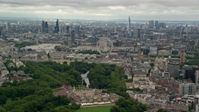 5.5K stock footage aerial video of the city of London seen while passing Buckingham Palace, England Aerial Stock Footage | AX115_265