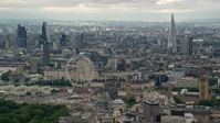 5.5K stock footage aerial video of the London Eye with skyscrapers in the background, England Aerial Stock Footage | AX115_266