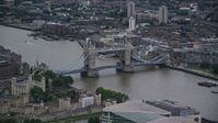 5.5K stock footage aerial video of flying by Tower Bridge spanning the River Thames in London, England, twilight Aerial Stock Footage | AX116_020