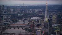 5.5K stock footage aerial video of a view of the Tower Bridge over River Thames near The Shard, London, England, night Aerial Stock Footage | AX116_104