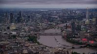 5.5K stock footage aerial video flyby bridges spanning River Thames, skyscrapers and cityscape, London, England, night Aerial Stock Footage | AX116_106