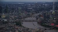 5.5K stock footage aerial video a view of bridges, River Thames, tall skyscrapers and cityscape, London, England, night Aerial Stock Footage | AX116_108