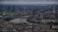 5.5K stock footage aerial video of towering skyscrapers and bridges spanning River Thames, London, England, night Aerial Stock Footage | AX116_112