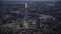 5.5K stock footage aerial video of flying by The Shard skyscraper by River Thames, London, England, night Aerial Stock Footage | AX116_146