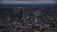 5.5K stock footage aerial video of flying by skyscrapers in Central London, London, England, night Aerial Stock Footage | AX116_147