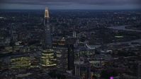 5.5K stock footage aerial video of The Shard skyscraper near the Tower Bridge, London, England, night Aerial Stock Footage | AX116_150