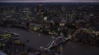5.5K stock footage aerial video orbiting Tower Bridge and River Thames near Tower of London, England, night Aerial Stock Footage | AX116_157