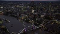 5.5K stock footage aerial video of Tower Bridge and River Thames near Tower of London and skyscrapers, England, night Aerial Stock Footage | AX116_158