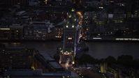 5.5K stock footage aerial video of slowly flying by Tower Bridge and River Thames, London, England, night Aerial Stock Footage | AX116_165