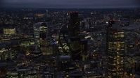 5.5K stock footage aerial video of The Gherkin skyscraper, seen from near Heron Tower, London, England, night Aerial Stock Footage | AX116_166