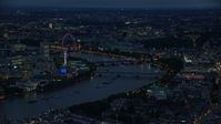 5.5K stock footage aerial video of approaching bridges spanning River Thames and London Eye, London, England, night Aerial Stock Footage | AX116_174