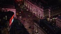 5.5K stock footage aerial video flying by crowds and double decker buses at Piccadilly Circus, London, England, night Aerial Stock Footage | AX116_182