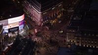 5.5K stock footage aerial video orbit crowds and double decker buses at Piccadilly Circus, London, England, night Aerial Stock Footage | AX116_184