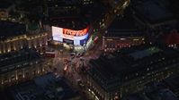 5.5K stock footage aerial video of orbiting crowds and buses at Piccadilly Circus, London, England, night Aerial Stock Footage | AX116_185