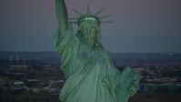 5.5K stock footage aerial video orbit the famous Statue of Liberty at sunrise, New York Aerial Stock Footage | AX118_059