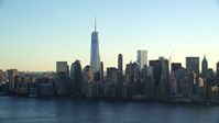 5.5K stock footage aerial video of approaching the Lower Manhattan skyline at sunrise in New York City Aerial Stock Footage | AX118_149E