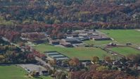 5.5K stock footage aerial video of a small time high school in Autumn, Syosset, New York Aerial Stock Footage | AX119_246