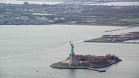 5.5K stock footage aerial video of a wide orbit of the Statue of Liberty in Autumn, New York Aerial Stock Footage | AX120_119E