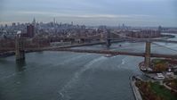 5.5K stock footage aerial video approach the Brooklyn and Manhattan Bridges at twilight in New York City Aerial Stock Footage | AX121_023
