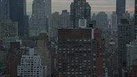 5.5K stock footage aerial video flyby streets and Midtown Manhattan skyscrapers at twilight in New York City Aerial Stock Footage | AX121_056E