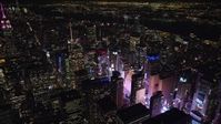 5.5K stock footage aerial video of circling the Bank of America Tower toward the glow of Times Square at Night, Midtown, NYC Aerial Stock Footage | AX122_115E