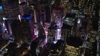 5.5K stock footage aerial video of Midtown Manhattan skyscrapers by Times Square at Night in NYC Aerial Stock Footage | AX122_127