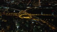 5.5K stock footage aerial video of riverfront freeway interchange by Robert F. Kennedy Bridge at Night, Harlem, New York City Aerial Stock Footage | AX123_031