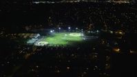 5.5K stock footage aerial video of flying over suburban homes toward baseball fields at Night in Hempstead, New York Aerial Stock Footage | AX123_157E