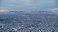 5.5K stock footage aerial video of Salt Lake City suburbs at Winter Sunrise in Utah Aerial Stock Footage | AX124_030