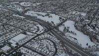 5.5K stock footage aerial video orbit light traffic on Interstate 80 through snowy Salt Lake City at sunrise, Utah Aerial Stock Footage | AX124_187