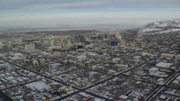 5.5K stock footage aerial video approach Downtown Salt Lake City buildings in winter snow at sunrise in Utah Aerial Stock Footage | AX124_194